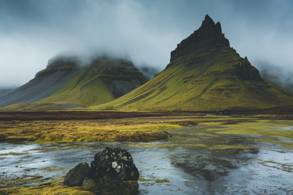 A mystical Icelandic landscape representing the essence of örviri, with mountains, mist, and a folkloric aura.